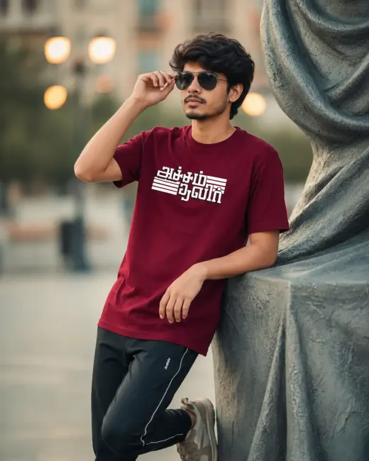 Unisex navy blue cotton-stretch t-shirt featuring 'Acham Thavir' Tamil typography on the chest