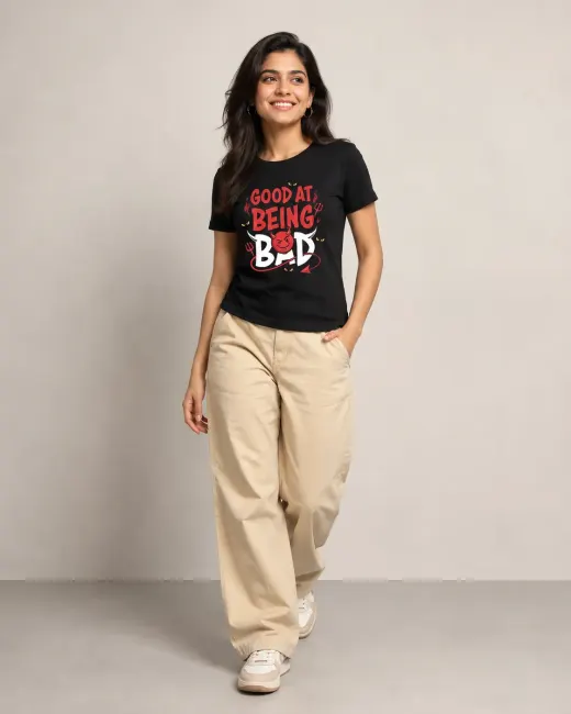 Black Supima cotton T-shirt with white 'Good At Being Bad' graphic across the chest