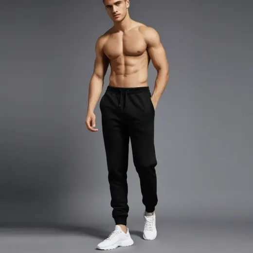 Men’s black tapered jogger pants displayed on a plain background, front view with elastic waistband and cuffed ankles