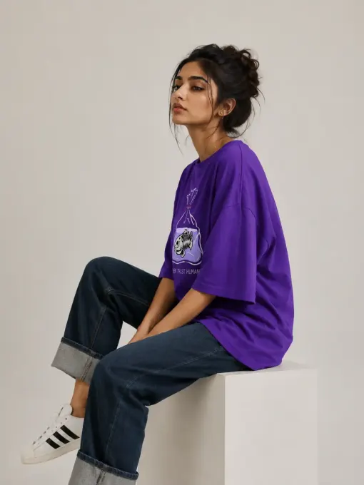 Front view of a model wearing the 'Never Trust Human' oversized graphic t-shirt, relaxed fit with bold chest lettering.