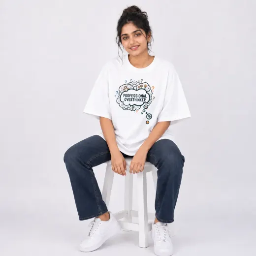 White oversized t-shirt with bold black 'Professional Overthinker' text, relaxed fit crew neck