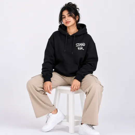 Black oversized pullover hoodie featuring a heavy-metal-style hand graphic on the chest