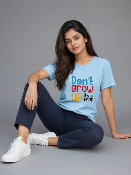 Unisex crew-neck oversized t-shirt featuring the typography 'Don't Grow Up It's A Trap' on the front