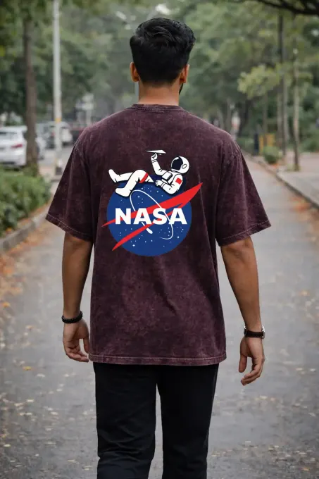 Unisex oversize acid-washed t-shirt featuring a NASA astronaut graphic, crew neck and short sleeves