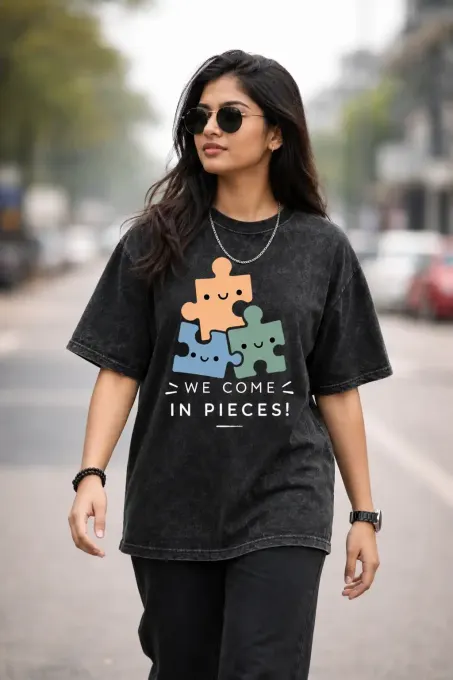 Unisex oversized acid-wash t-shirt with 'We Come In Pieces' graphic and relaxed drop-shoulder fit