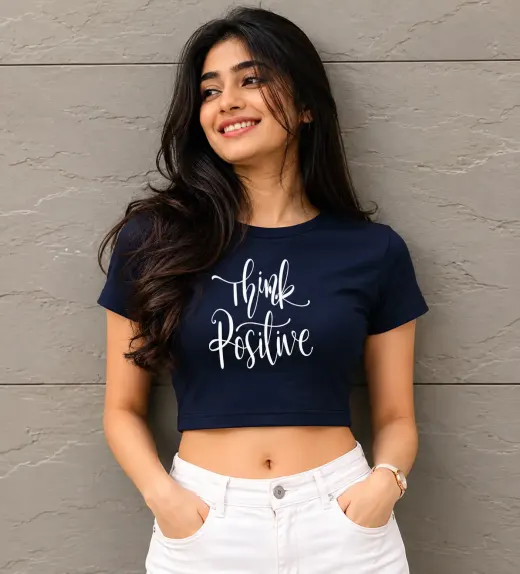 Female model wearing "Think Positive" premium cotton crop top, front view